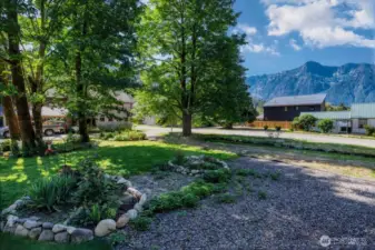 Enjoy low-maintenance perennial gardens, mtn views and the comfort of shade trees.