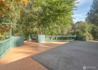 Large deck off living room leads to creek.