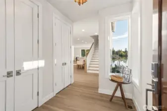 Step inside through the welcoming foyer where natural light pours in, setting the tone for the home’s warm and refined aesthetic. High ceilings and quality finishes immediately convey a sense of calm and sophistication.