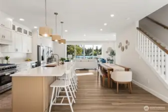 The expansive great room creates a seamless flow between living, dining, and kitchen spaces. Designed for both entertaining and relaxing, it’s a gathering place that feels as inviting as it is impressive.
