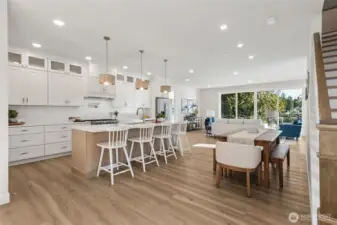 This stunning kitchen is a chef’s dream, equipped with premium appliances, quartz countertops, and soft-close custom cabinetry. Every detail is designed for functionality and beauty, making it the heart of the home.