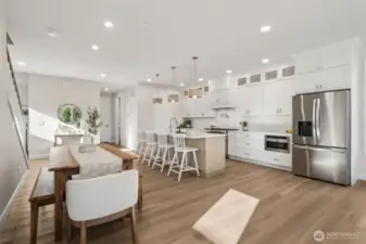 The dining area flows effortlessly from the kitchen, providing the perfect setting for both casual meals and elegant entertaining—all while maintaining a warm, inviting atmosphere that celebrates lakeside living.