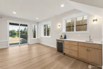 Lower level with wet bar and beverage fridge. A great space to host Summer gatherings or second living area with a 4th bedroom and large 3/4 bath.