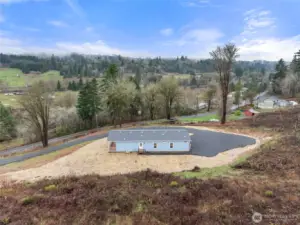 Aerial shot of the back side of the home.  Door leads to the utility room.