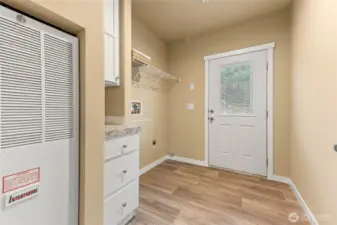 Off the living room is the utility room and door leading to the back yard area.