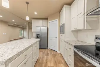 Door to the right of the refrigerator is a walk-in pantry.