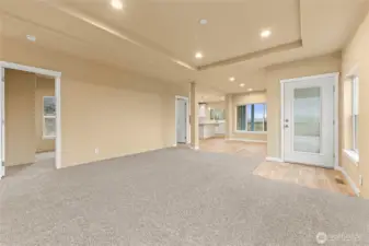 This shot from the living room shows door to the left is the first guest room, and door two by the kitchen is the utility room.