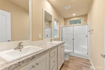 His/her sinks and walk-in shower in the primary bathroom