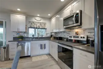 Quartz countertops and stainless steel appliances.