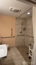 Large hallway bathroom upstairs with roll in shower