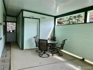 Virtual of the carport with enough room for a covered patio next to the storage building.