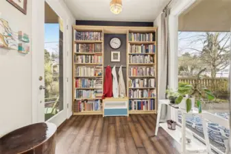 Lovely entry welcomes you in with floor-to-ceiling windows.