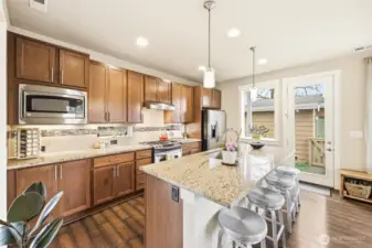 Kitchen positioned within functional layout and charming below cabinet windows for additional light.