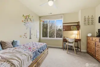 Well lay out bedroom with large windows flooding the space with natural light.