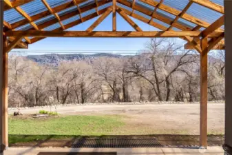 Covered patio standing at the front door, facing East