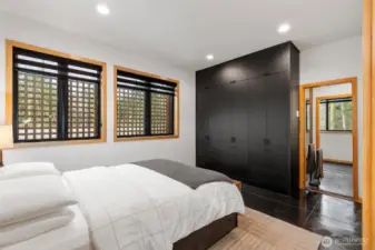 Custom closet stretches across the back wall and to the ceiling, providing plenty of storage options.