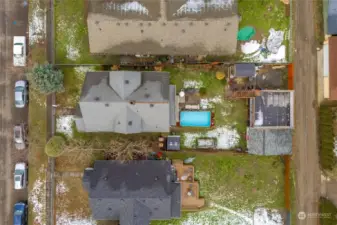 Aerial view of the lot showing the Pool, Rooftop Deck over detached garage, and mature landscaping.