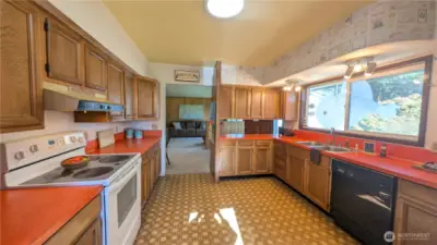 Bright and colorful kitchen with picture window facing the yard.