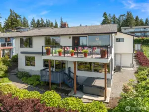 Dual deck and lush gardens surround this beautiful home.