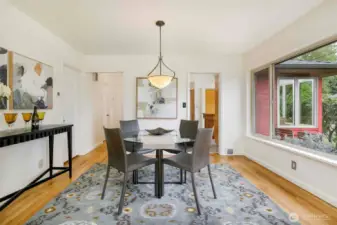 Spacious formal dining room seamlessly connected to the kitchen, featuring natural light and plenty of room for hosting dinner parties or everyday family meals in this Broadview beauty.