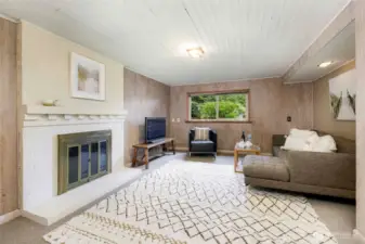 Cozy and spacious finished basement family room with a second fireplace—ideal for movie nights, game days, or casual gatherings in this North Seattle home.