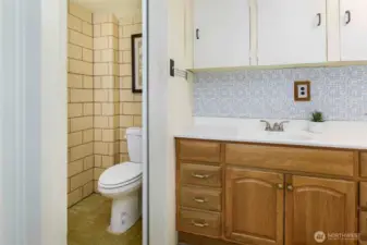Functional second bathroom downstairs, supporting multigenerational living or flexible guest accommodations.