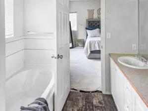 View of soaking tub and double sinks to the bedroom.