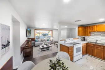 A spacious living area anchored by a big picture window brings in plenty of natural light and neighborhood views. *virtually staged*