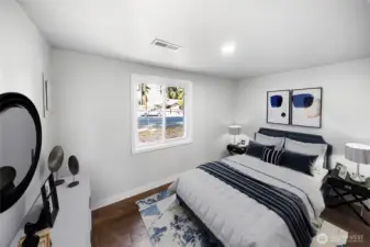 This cozy bedroom offers warm natural light, fresh paint, and new flooring — perfect for a guest room, office, or personal retreat. *virtually staged*