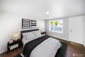 The spacious primary suite features oversized windows, sleek LVP flooring, and a clean modern feel — your ideal spot to relax and recharge. *virtually staged*