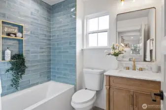Main level hall bathroom with artisan tiled shower/tub combo