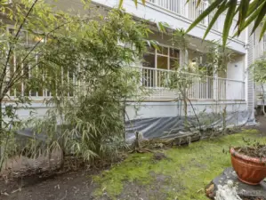 Just outside the unit is a lush garden space providing privacy from the neighboring building.