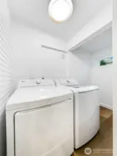 Laundry room is off the kitchen, with extra storage space too.