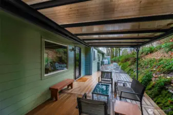 Cozy covered Trex deck is easy care, usable year 'round and located off of the living room and kitchen. Use the kitchen window as a handy pass through while entertaining friends and family back here