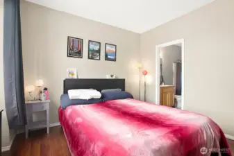 The spacious primary suite is a true retreat, featuring a walk-in closet, additional linen storage, and a private bath.
