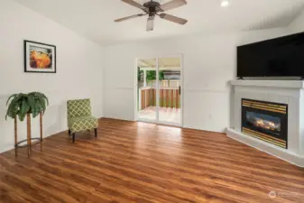 Gas fireplace in this fantastic extra space & a slider to the backyard & covered deck.