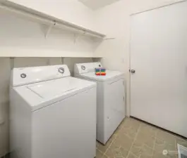 Utility room between the garage & the house. Washer & dryer stay with the property.