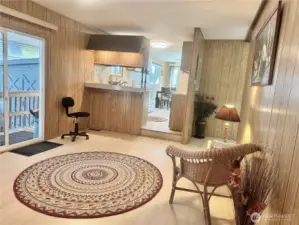 Sitting room or den? Use your imagination! So much light, it would make a beautiful library of office area.