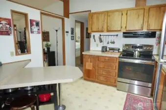 Kitchen with newer stove and lots of cabinets.