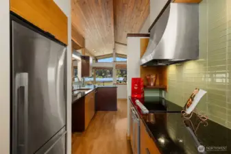 A view through to the dining room, deck and views beyond.