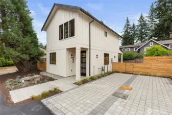 Boldly modern with clean vertical lines, this home welcomes with a crisp tile entry, lush perimeter landscaping, and a striking address column—plus ample parking that blends seamlessly into the minimalist design.