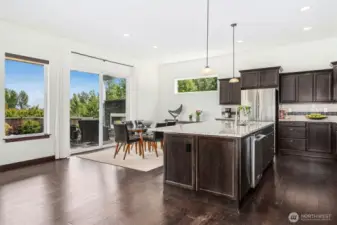 Elegant dining area that flows out onto the expansive covered composite deck with outdoor fireplace & patio