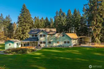 Back of the home. Doesn't evenn show everything like the chicken coop etc. Notice the heated & A/C she shed.  RV Parking area on the right side.