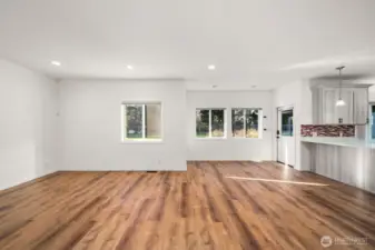 Open concept living room adjacent to the kitchen & eating nook. Overlooks the backyard which has trees behind it for added privacy. and a beautiful view.