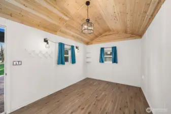 Inside of the she shed. Mini Split Pine ceilings, laminate planked flooring, all new.