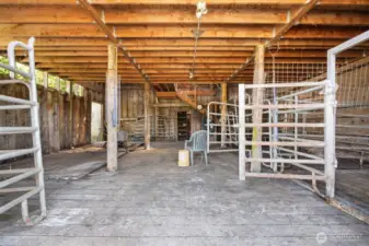 Interior of barn with new flooring and supports for the upper story.
