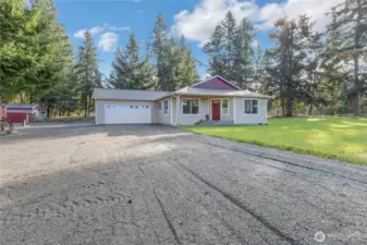 Rambler on 5 acres. Shop/detached garage and barn off to the left.