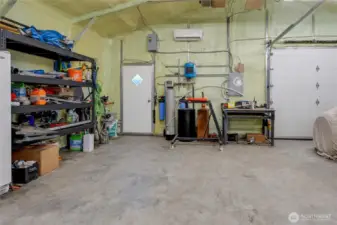 Detached shop showing water softner and well components