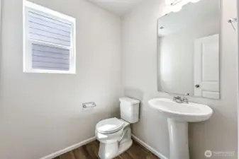 1/2 bath on Main-Disclaimer- Photos are from a similar floor plan from another community, photos are for illustrative purposes only. Finishes, flooring, features, upgrades, countertops, paint, colors, and other features may vary.