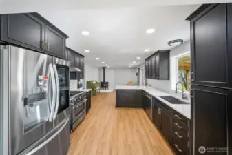 Gorgeous and tastefully updated kitchen showcases ebony black cabinetry with handsome brass hardware. All appliances are inlcluded